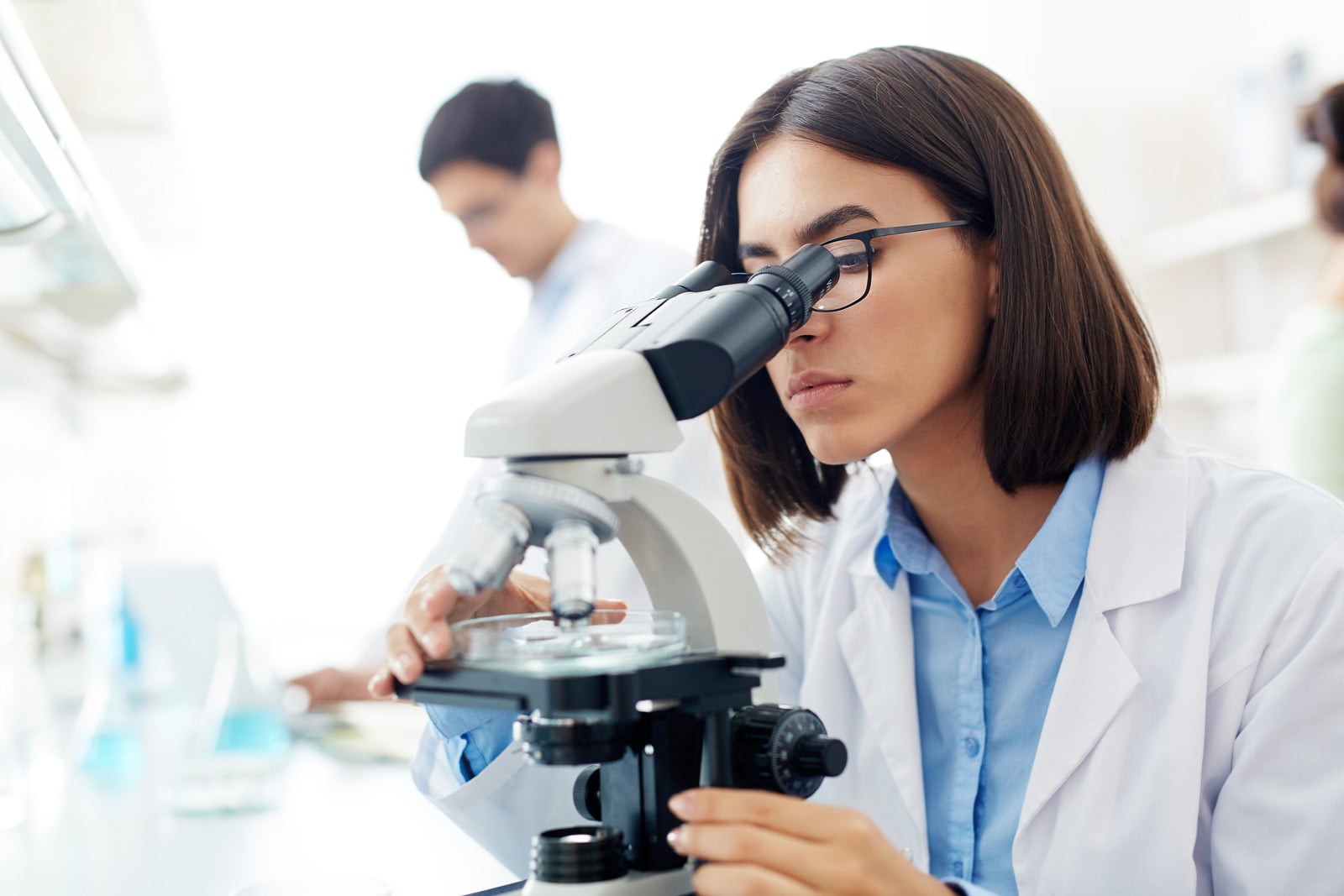 Woman looking through microscope